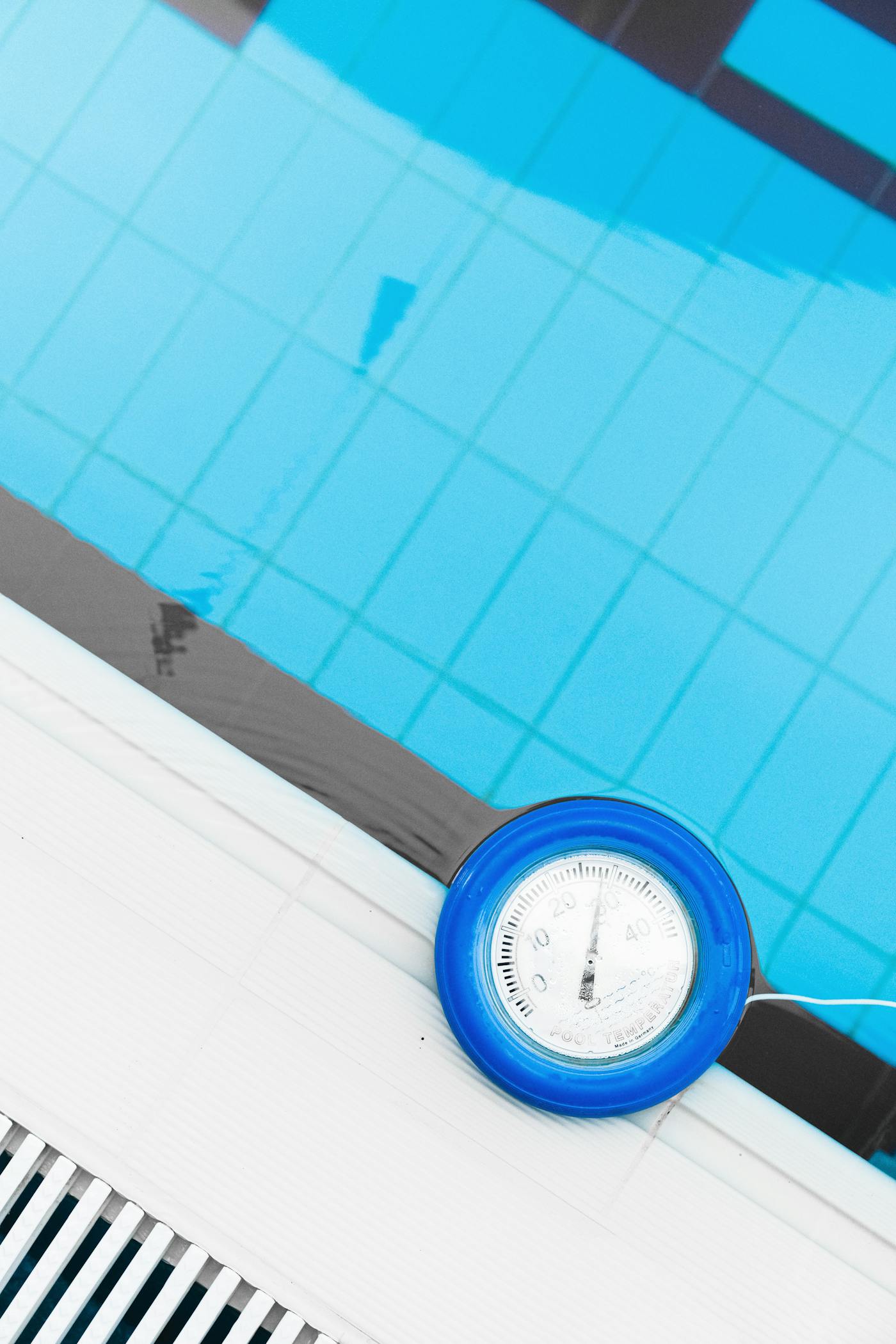 Pool thermometer floating in residential pool